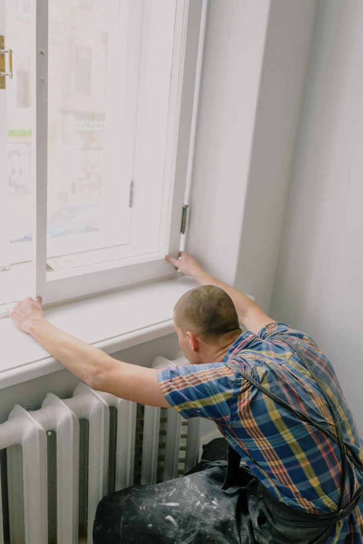 Fitting and squaring a window frame during an interior repair